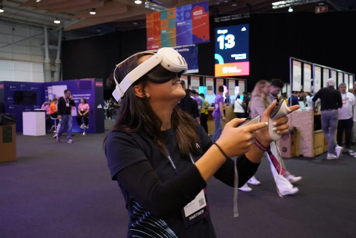 A team member trying a virtual reality headset at a technology event