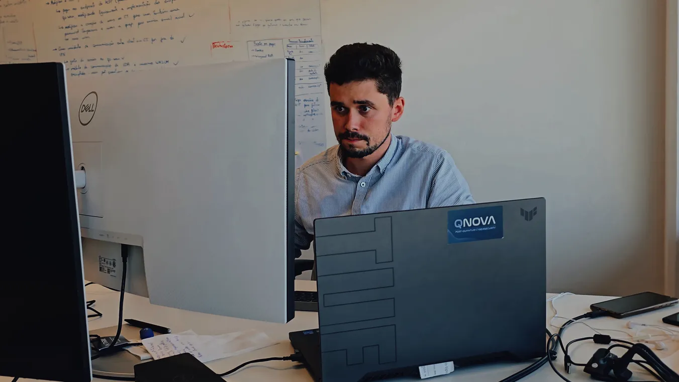 A team member working on a laptop at the office