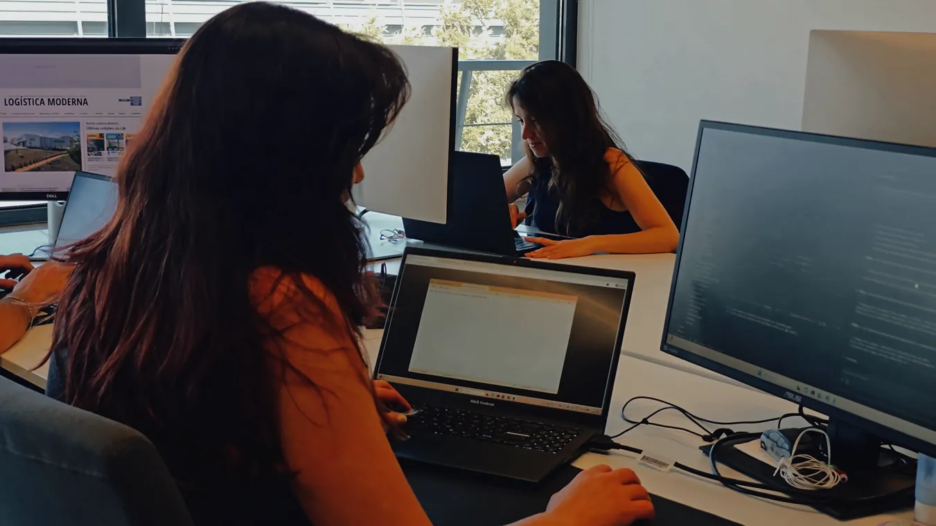 A team member working with two screens at the office