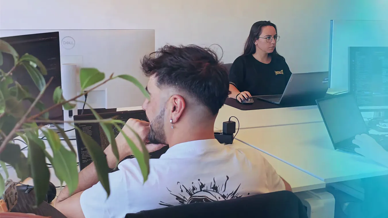 Two team members working at their desks